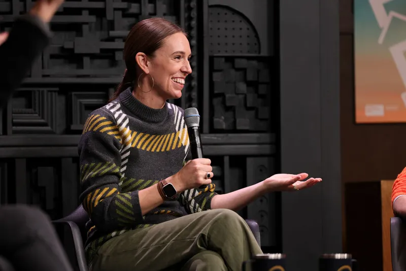 A woman holds a microphone and smiles