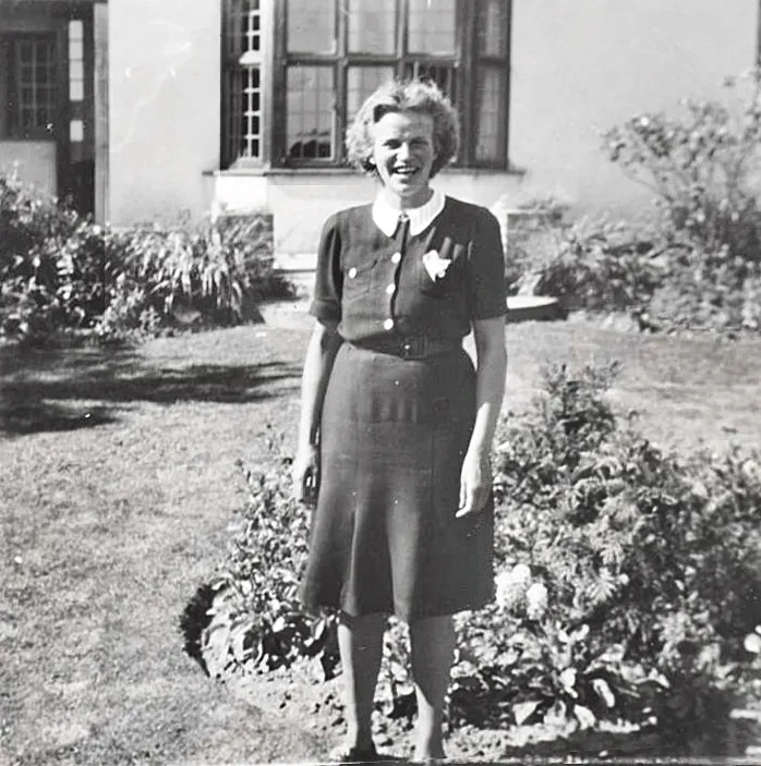 A black and white picture of a nanny in uniform