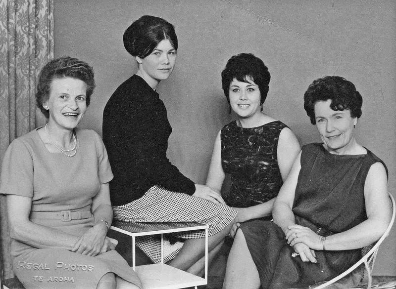 A black and white photo of four women in the 1960s