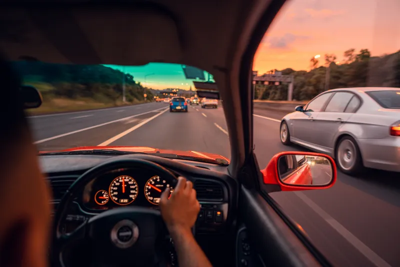 Man driving a car on an Auckland motorway