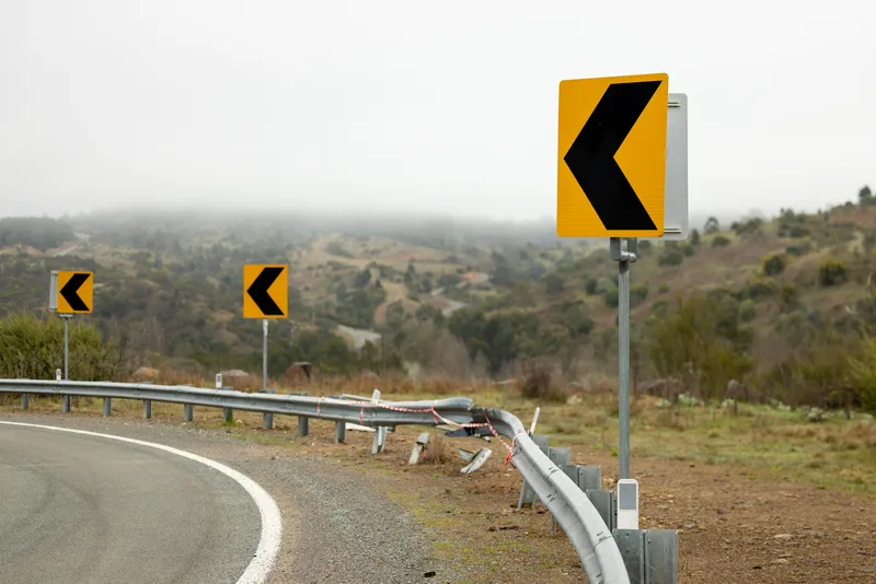A roadside barrier showing the after-effects of a crash