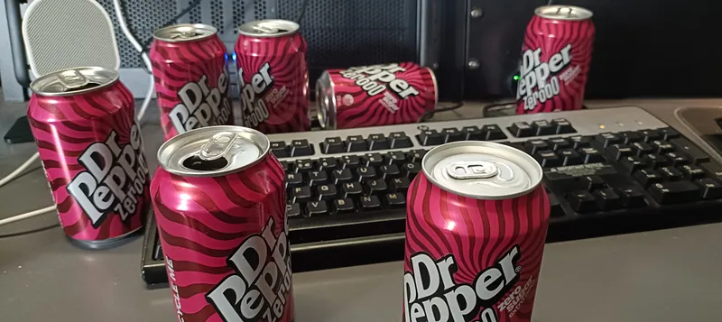 Cans of Dr Pepper around a keyboard
