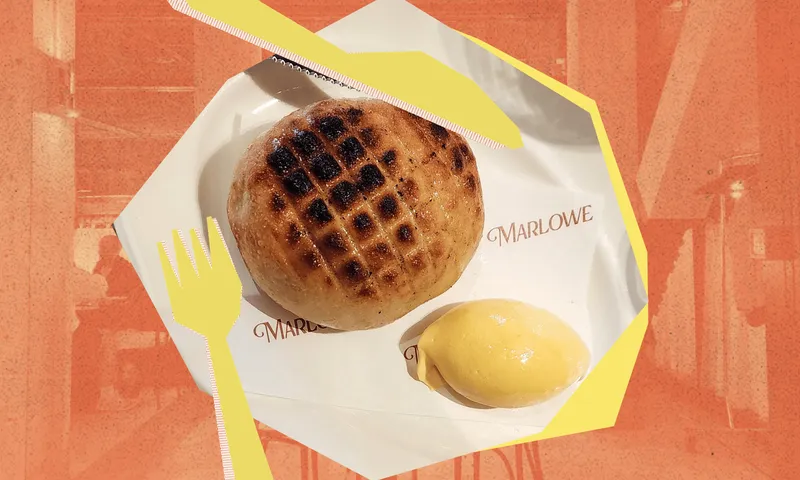 A stylised orange background with a geometric plate and knife and fork image and a bread roll and quenelle of butter. On the plate the word Marlowe is visible