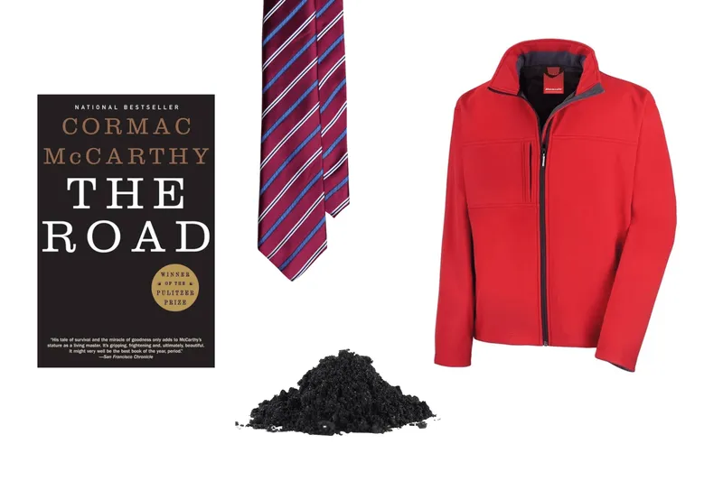 A copy of The Road, a tie, red jacket and a pile of ash.
