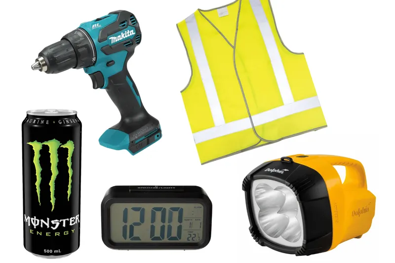 A power drill, high vis vest, torch, alarm clock and can of Monster energy drink.