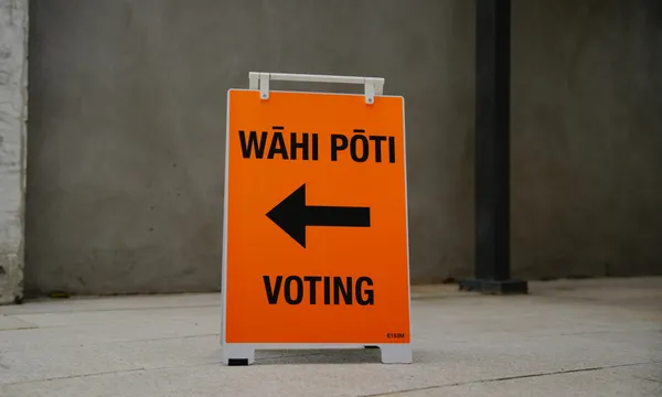 An orange election sign reading "wāhi pōti – voting" with a black arrow pointing left