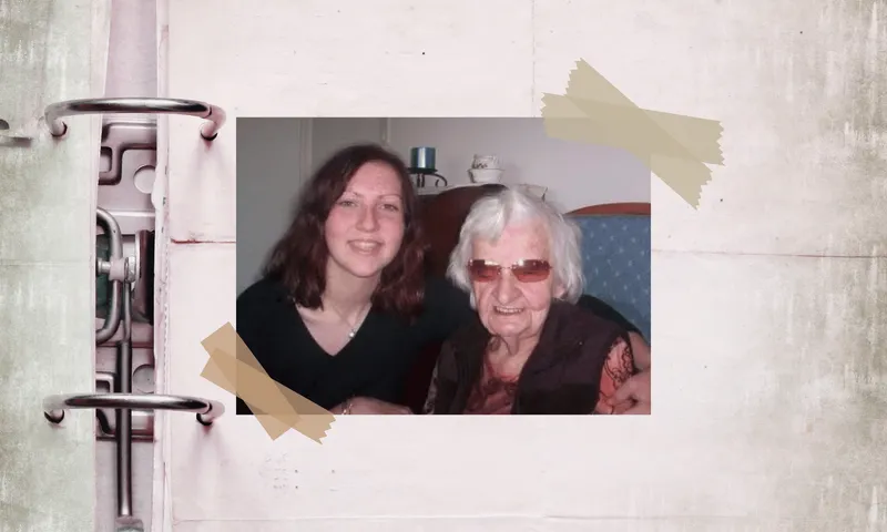 a young woman with curly brown hair sits next to an elderly woman with short white hair and tinted glasses